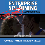 Top portion features the EnterpriseSplaining logo with the subheading “A Star Trek Podcast” Middle portion is an image from the Enterprise episode Rajiin showing Close up Archer facing a blonde woman. She is looking intensely at him and he is looking confused and a little worried. with the words “Star Trek Enterprise: Rajiin. Below, there’s a section in blue with the white letters saying “Commotion at the Lady Stall!” Over the image is a stamp saying “SECOND CONTACT”
